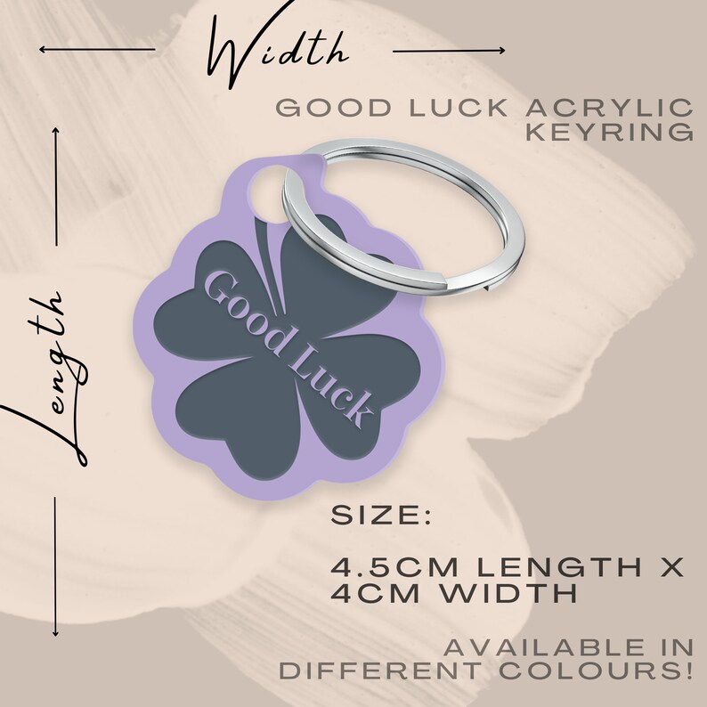 May include: Purple acrylic keyring with a four-leaf clover design. The clover is dark grey with the words "Good Luck" written inside. The keyring is 4.5 cm long and 4 cm wide.