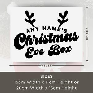 May include: A white rectangular sign with black text that reads "ANY NAME'S Christmas Eve Box." The sign features reindeer antlers above the text. Available in two sizes: 5.9" width x 4.3" height or 7.9" width x 5.9" height.
