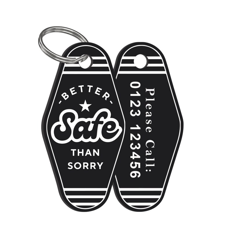 May include: Black and white motel key chain with the text "Better Safe Than Sorry" and a star on one side and a phone number on the other side. The text "Please Call: 0123 123456" is printed on the other side.
