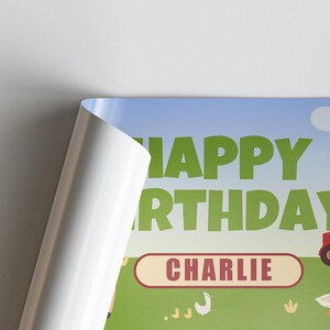 May include: A birthday-themed poster with the words "HAPPY BIRTHDAY" in green letters against a blue sky background. The name "CHARLIE" is in a red oval. A tractor and farm animals are also visible.