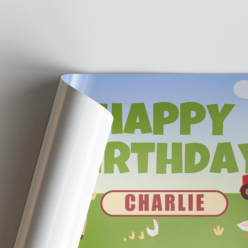 May include: A birthday-themed poster with the words "HAPPY BIRTHDAY" in green letters against a blue sky background. The name "CHARLIE" is in a red oval. A tractor and farm animals are also visible.