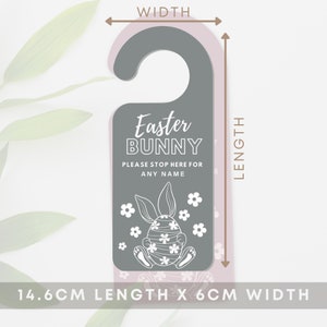 May include: A gray door hanger with the text "Easter BUNNY" and "PLEASE STOP HERE FOR ANY NAME". It features a white illustration of a bunny on an egg with flowers. The door hanger is 5.7 inches long and 2.4 inches wide.