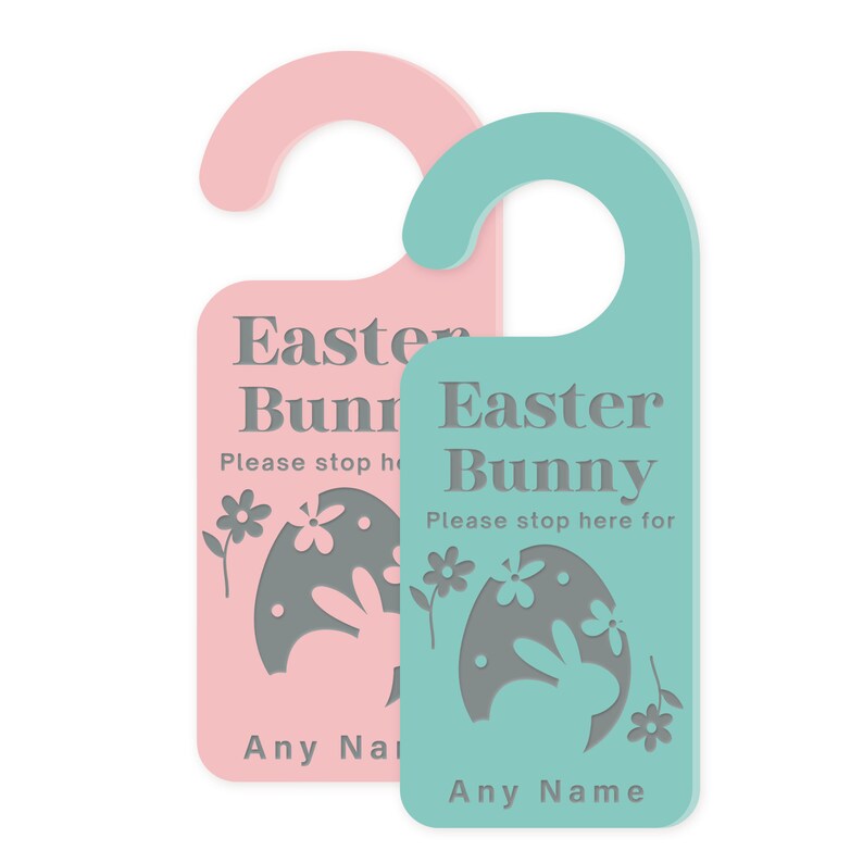 May include: Two Easter bunny door hangers, one pink and one teal, with a gray bunny silhouette inside an egg. The text on the hangers reads "Easter Bunny" and "Please stop here for... Any Name".