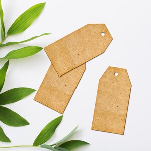 May include: Three brown paper gift tags with a hole punched in the top. The tags are on a white background with green leaves.