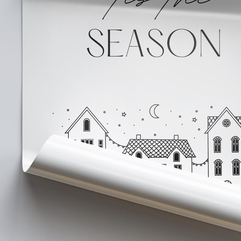 May include: Black and white printable wall art featuring a row of houses with a crescent moon and stars in the sky. The text "Tis the Season" is at the top of the print.