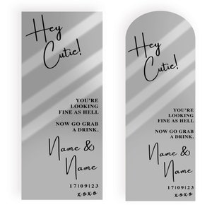 May include: Two gray rectangular cards with a shadow effect. The text on the cards reads "Hey Cutie! You're looking fine as hell. Now go grab a drink. Name & Name 17/09/23 xoxo".