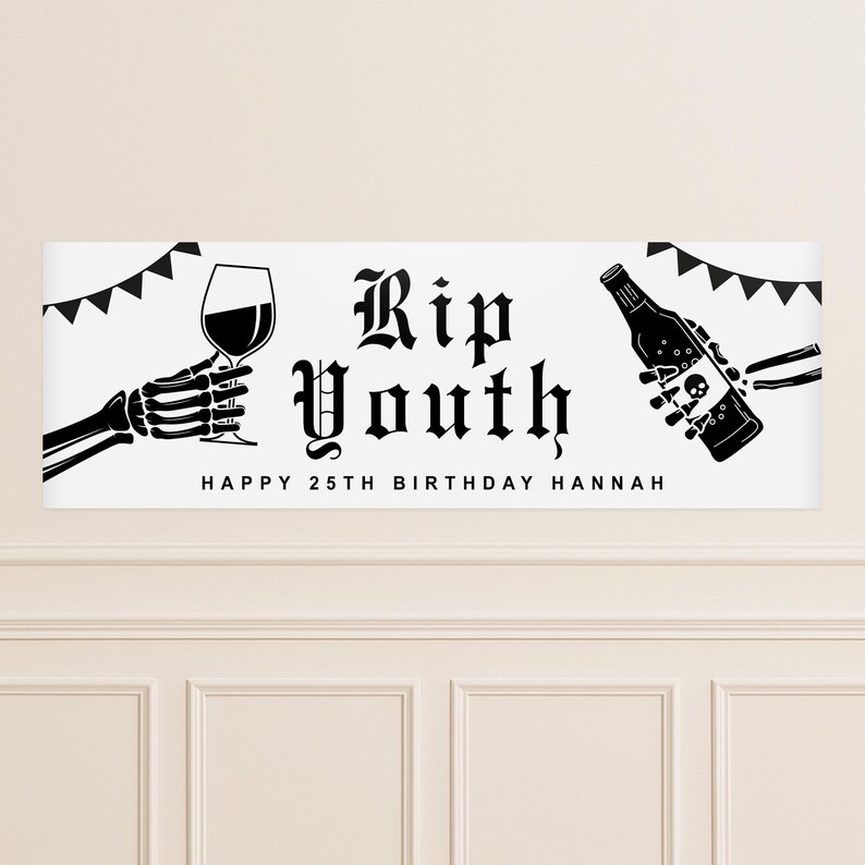 May include: A white banner with black graphics and text. The banner reads "Rip Youth" in gothic font, with "Happy 25th Birthday Hannah" below. A skeleton hand holds a wine glass, and another holds a bottle.
