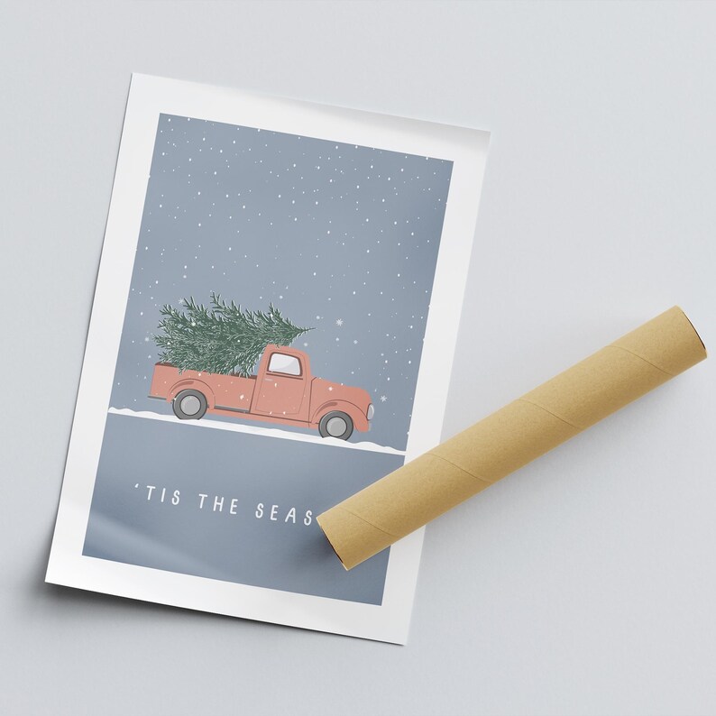 May include: A red pickup truck with a Christmas tree in the bed, driving through a snowy scene. The text 'Tis the Season is written below the truck.