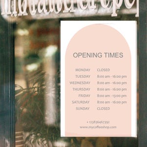 May include: A sign displaying the opening times for a coffee shop. The sign has a light pink background with the words "OPENING TIMES" at the top. The hours of operation are listed for each day of the week, with the shop closed on Mondays and Sundays.