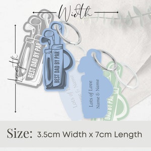 May include: Three golf-themed keychains with silver key rings. The keychains are blue, gray, and green. The blue keychain has the text "BEST DAD BY PAR" and "Lots of Love Name & Name". The gray keychain has the text "BEST DAD BY PAR". The green keychain has the text "DAD BY PAR". The keychains are 3.5 cm wide and 7 cm long.