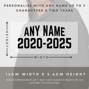 May include: A black hoodie with a white rectangle on the front. The rectangle has the text "ANY NAME 2020-2025" in black. The hoodie is 14 cm wide and 5.6 cm high.