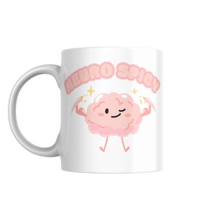 Puede incluir: Taza de cer&aacute;mica blanca con un personaje de dibujos animados de cerebro rosa flexionando sus m&uacute;sculos y el texto "Neuro Spicy" en letras rosas.