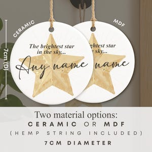May include: Two white ceramic or MDF star-shaped ornaments, 7cm in diameter, with hemp string. Each ornament features a gold star design and the text "The brightest star in the sky... Any name".