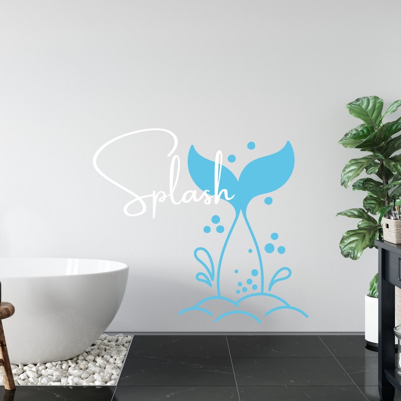 May include: A blue mermaid tail with bubbles and the word "Splash" in white cursive on a white wall.