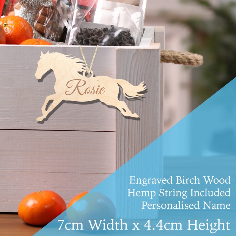 May include: Wooden horse ornament with the name "Rosie" engraved on it. The ornament is 7 cm wide and 4.4 cm high. It comes with a hemp string for hanging.