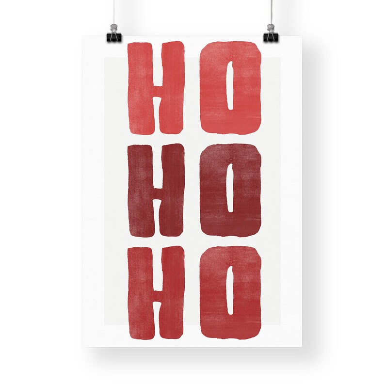 May include: A white poster with the words "HO HO HO" in a bold, red, block-letter style. The letters are arranged in three rows of two, with each word stacked vertically. The design has a festive, holiday theme.