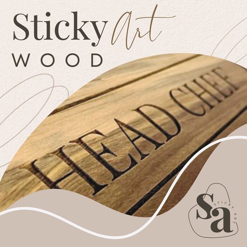 May include: A close-up of a wooden sign with the text "HEAD CHEF" engraved in black lettering. The sign is made of light brown wood with a natural grain pattern. The text "Sticky Art WOOD" is visible in the top left corner of the image.