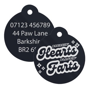 May include: Black round pet ID tag with white text. The tag has a phone number, address, and the text "Breakin' Hearts Blastin' Farts".