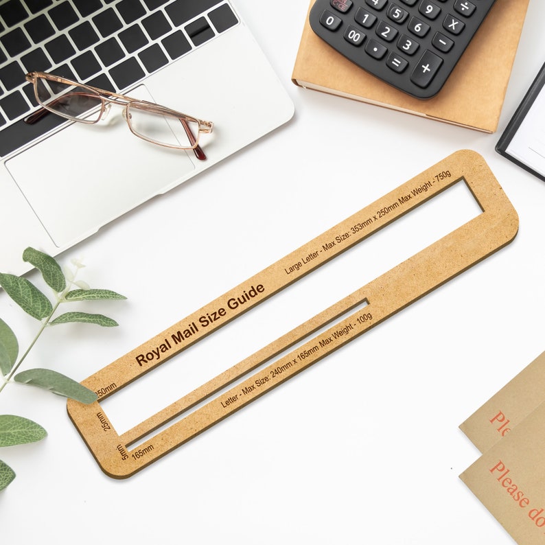 May include: A wooden Royal Mail size guide with two cutouts for measuring the dimensions of letters and large letters. The guide is labeled with the maximum size and weight for each type of letter.