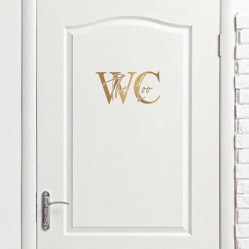 May include: A white door with a gold decal that says "WC the Loo" on it.