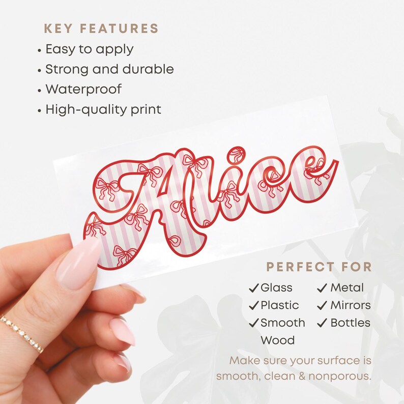 May include: A white sticker with the name "Alice" in a red, bow-adorned font. The name is set against a pink and white striped background. The sticker is designed for use on glass, metal, plastic, mirrors, smooth wood, and bottles.