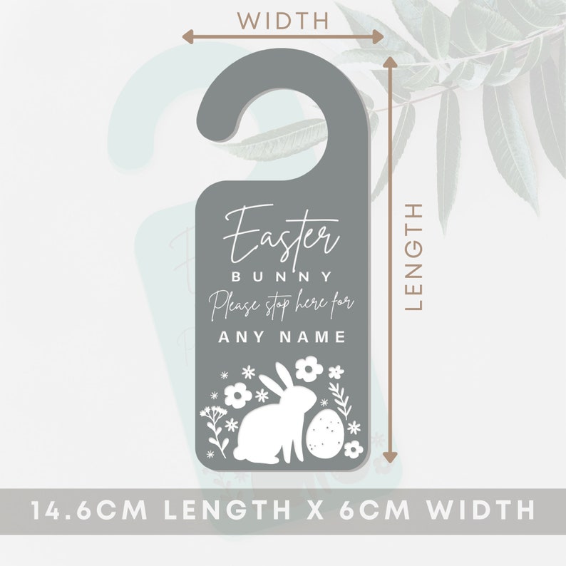 May include: Gray door hanger with a white bunny and Easter egg design. The text reads "Easter Bunny Please stop here for ANY NAME". The hanger measures 14.6 cm in length and 6 cm in width.