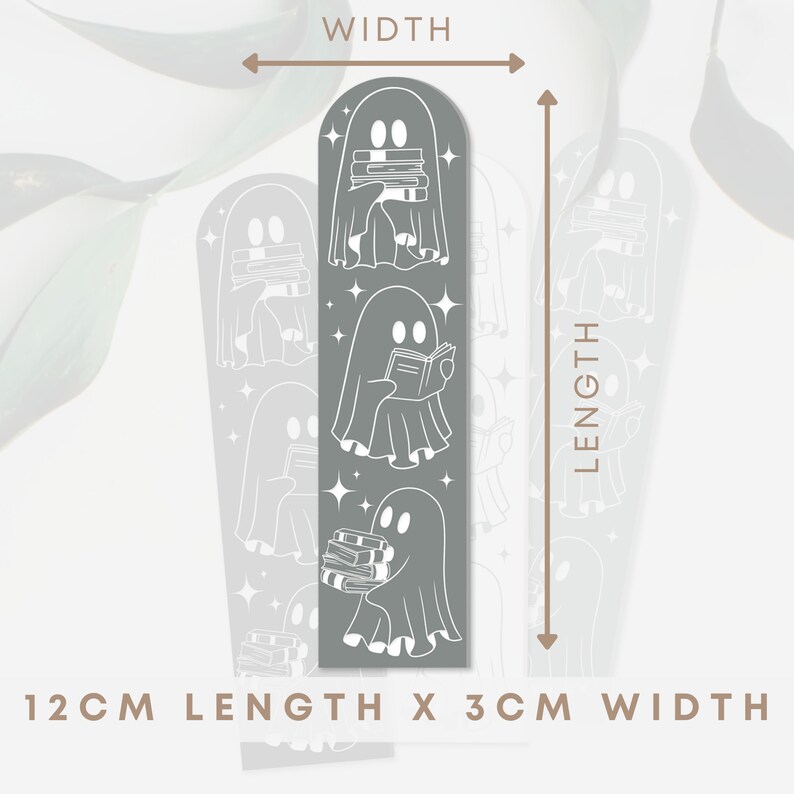 May include: A grey bookmark with a repeating pattern of white ghosts holding books. The bookmark is 12 cm long and 3 cm wide.  "12CM LENGTH X 3CM WIDTH" is printed at the bottom of the bookmark.