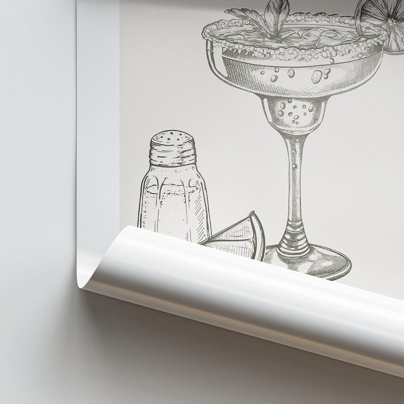 May include: A black and white line drawing of a margarita glass with a lime wedge, a salt shaker, and a sprig of mint.