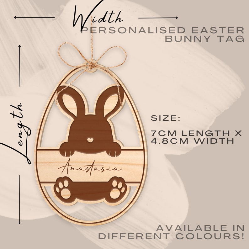 May include: Personalized Easter bunny tag in the shape of an egg with a brown bunny peeking out. The tag is made of wood and has a space for a name, in this case, "Anastasia". The tag measures 7 inches in length and 4.8 inches in width.
