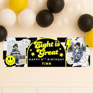 May include: A banner with the text "Eight is Great" in yellow, celebrating an 8th birthday. The banner includes photos of a child, a smiley face, a dice, and balloons in black, white, and yellow.