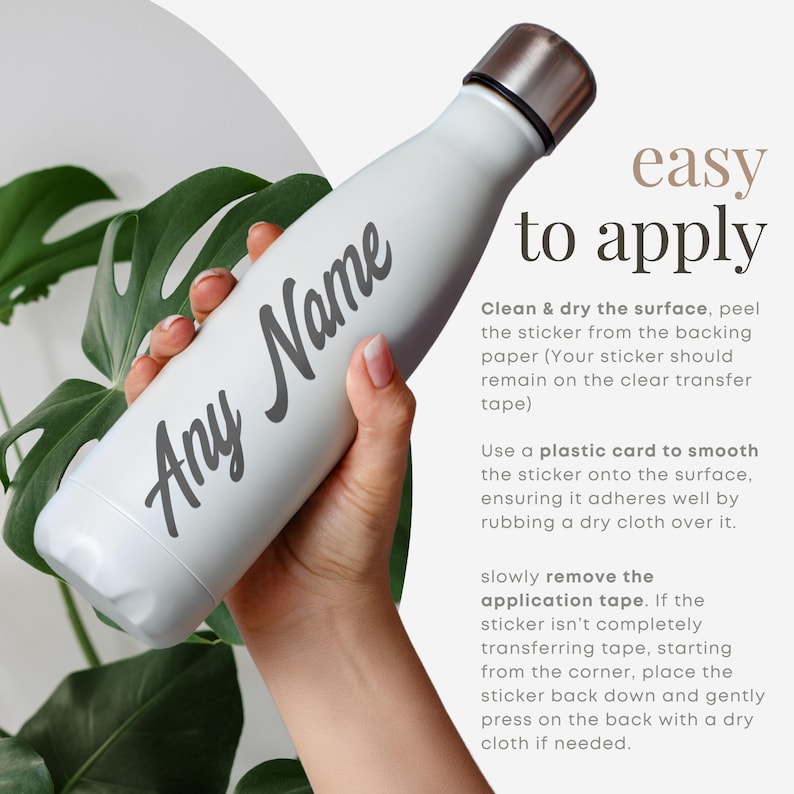 May include: A white reusable water bottle with a gray sticker that says "Any Name" on it. The bottle is being held by a hand. The image includes instructions on how to apply the sticker to the bottle.