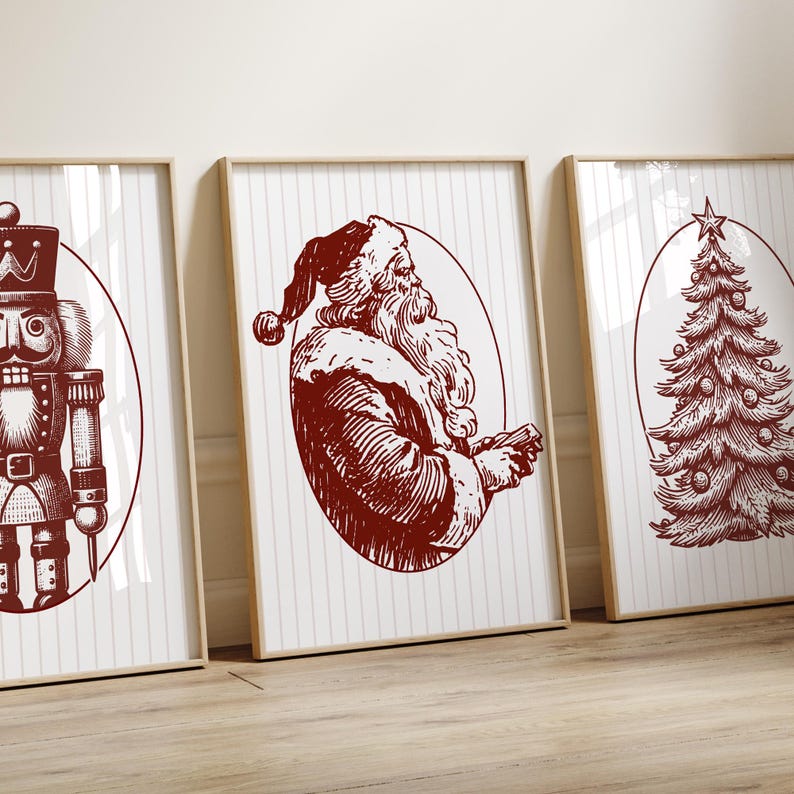 May include: Three framed Christmas-themed prints. The prints feature a nutcracker, Santa Claus, and a Christmas tree, all in a vintage red and white color scheme. The artwork is set against a white background with vertical stripes.
