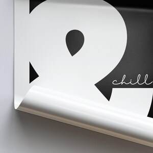 May include: Black and white graphic print with the word "chill" in white text. The graphic is a stylized letter "R" with a black background.