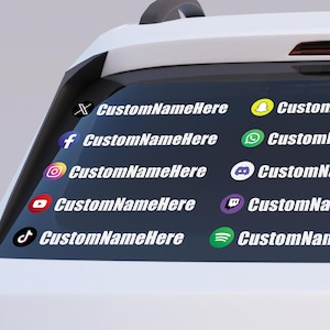 May include: A car window decal featuring social media icons and the text "CustomNameHere" in white. Icons include X, Facebook, Instagram, YouTube, TikTok, Snapchat, WhatsApp, Discord, Twitch, and Spotify.