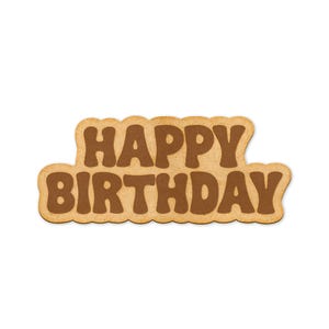 May include: A brown cardboard sign with the words "Happy Birthday" in brown lettering.
