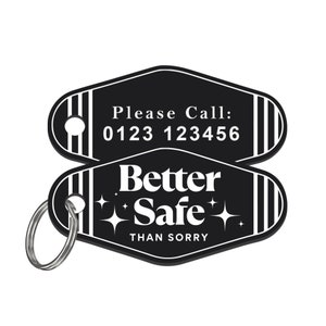 May include: Black motel key tag with white text that reads "Please Call: 0123 123456" on the top and "Better Safe Than Sorry" with two white stars on the bottom. The key tag has a silver key ring.