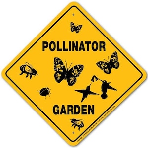 May include: Yellow diamond-shaped sign with black text that reads "Pollinator Garden". The sign features black silhouettes of a hummingbird, butterflies, bees, and a beetle.