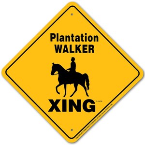 May include: Yellow diamond-shaped sign with black text and a silhouette of a person riding a horse. The sign reads "Plantation WALKER XING".