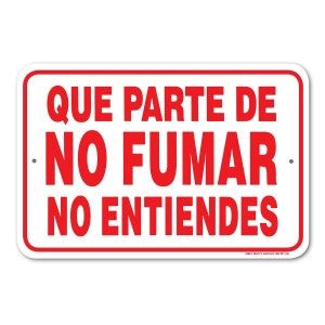 May include: White sign with red text that reads "QUE PARTE DE NO FUMAR NO ENTIENDES".