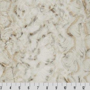 May include: White faux fur fabric with a subtle brown swirl pattern. The fabric has a soft, plush texture.