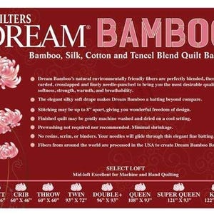May include: A red sign with the text "QUILTERS DREAM BAMBOO" and product details. The sign also features pink flower illustrations and size specifications for various quilt sizes, including Craft (46" x 36") and King (122" x 120").