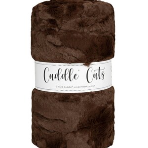 May include: A roll of brown minky fabric with the label "Cuddle Cuts" and the text "2 Yard Cuddle® minky fabric precut".