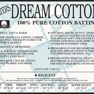 May include: A white and blue sign for Dream Cotton batting. The sign lists features like soft, warm, and pure cotton. Sizes include Craft (46" x 36") to King (122" x 122").
