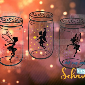 May include: Three mason jars with fairy silhouettes inside. Each jar has a different fairy design and is filled with glitter. The jars are on a blurred background of orange and yellow lights.