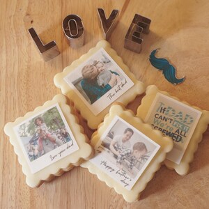 May include: Four decorated sugar cookies with images and text. The cookies are square shaped with rounded edges. The text on the cookies reads "The best dad", "We're all screwed", "Happy Father's Day", and "Love you dad".