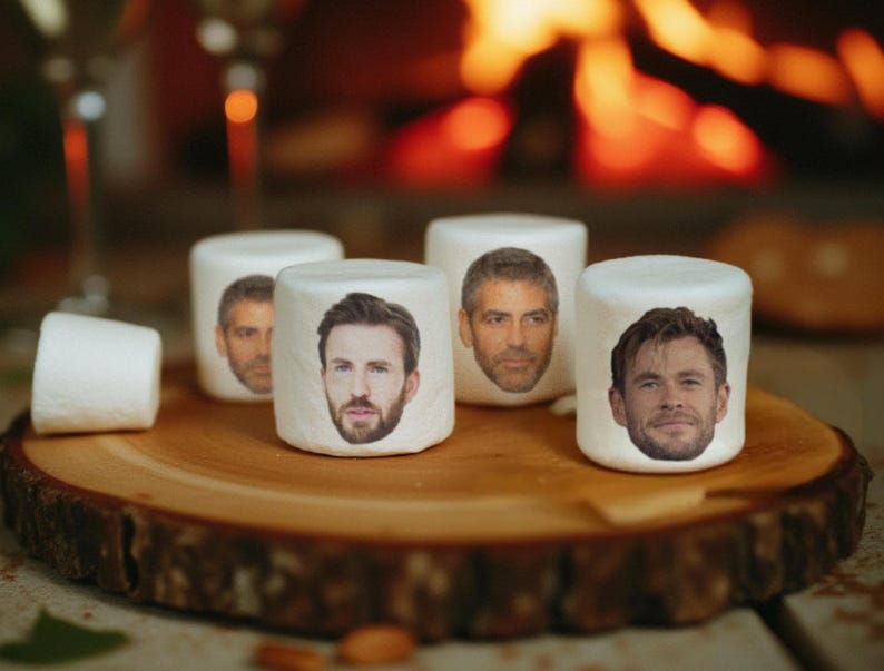 May include: White marshmallows with celebrity faces printed on them are arranged on a wooden serving board. The marshmallows are cylindrical and have images of famous actors. The background includes a blurred fireplace and glasses.