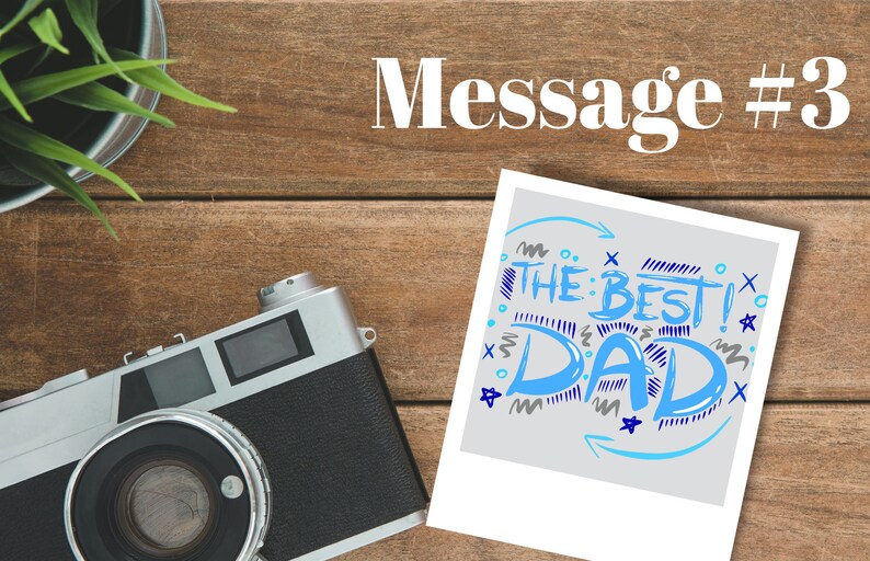 May include: A white photo card with a blue and grey handwritten message that says "The Best Dad!" with blue and grey stars and squiggles around the text.