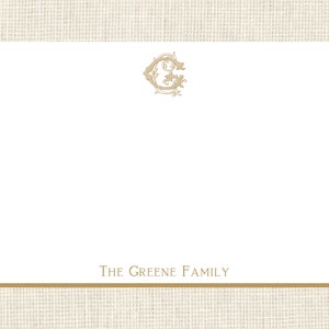 May include: A white card with a gold monogram of the letter G and the text "THE GREENE FAMILY" at the bottom.