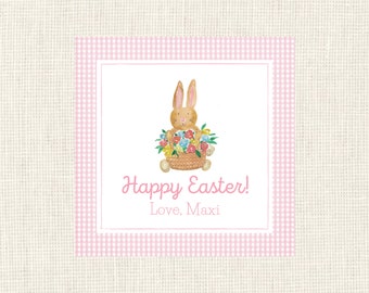 May include: A pink and white gingham border surrounds a white card with a cartoon bunny holding a basket of flowers. The card reads "Happy Easter! Love, Maxi".