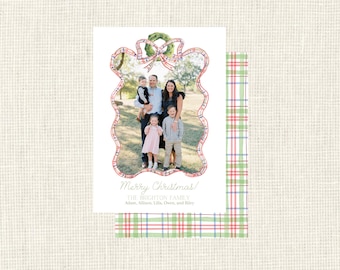May include: A Christmas card with a family photo inside a plaid frame. The card reads "Merry Christmas!" and the family name. The design uses red, green, and blue plaid, with a wreath detail at the top. The card is rectangular.